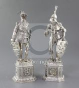 A pair of early 20th century German parcel gilt silver & card ivory figures, modelled as Knights,