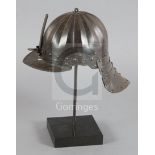 A Cromwellian lobster tail helmet, with radiating flutes, sliding nasal bar, front peak, four