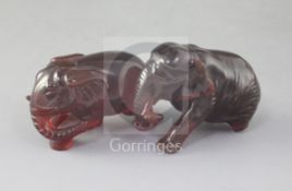 Two natural cherry amber figures of elephants, late 19th/early 20th century, each naturalistically