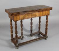 An early 18th century marquetry inlaid walnut side table, with folding top resting upon a double
