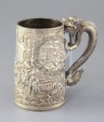 A mid-19th century Chinese silver mug, the body featuring warriors fighting to one side, with
