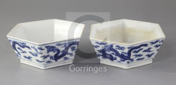 A pair of Chinese blue and white 'dragon' hexagonal bowls, early 20th century, each painted with