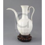 A Chinese white glazed ewer, Liao dynasty or later, the ten lobed body applied with a scrolled