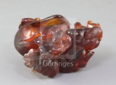 A Chinese amber brushwasher, Qing dynasty, finely carved with two rats clambering over gourds and