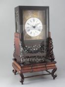 A 19th century Chinese hardwood mantel clock, of characteristic design, the pierced and carved stand