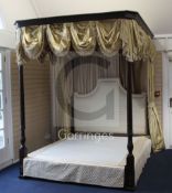 A George III STYLE mahogany four poster bedstead, with yellow silk drapes,
