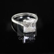 A modern platinum and emerald cut solitaire diamond ring, the stone weighing approximately 2.