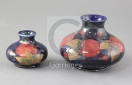 Two Moorcroft pomegranate pattern squat baluster vases, the smallest with impressed Moorcroft Potter