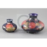 Two Moorcroft pomegranate pattern squat baluster vases, the smallest with impressed Moorcroft Potter