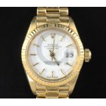 A lady's 18ct gold Rolex Oyster Perpetual Datejust wrist watch, with white dial, baton numerals