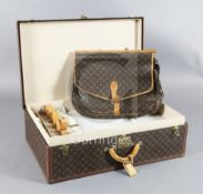 A large Louis Vuitton suitcase, with tan leather handle, and original internal tray and straps, no.