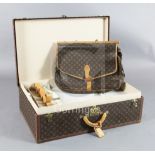 A large Louis Vuitton suitcase, with tan leather handle, and original internal tray and straps, no.