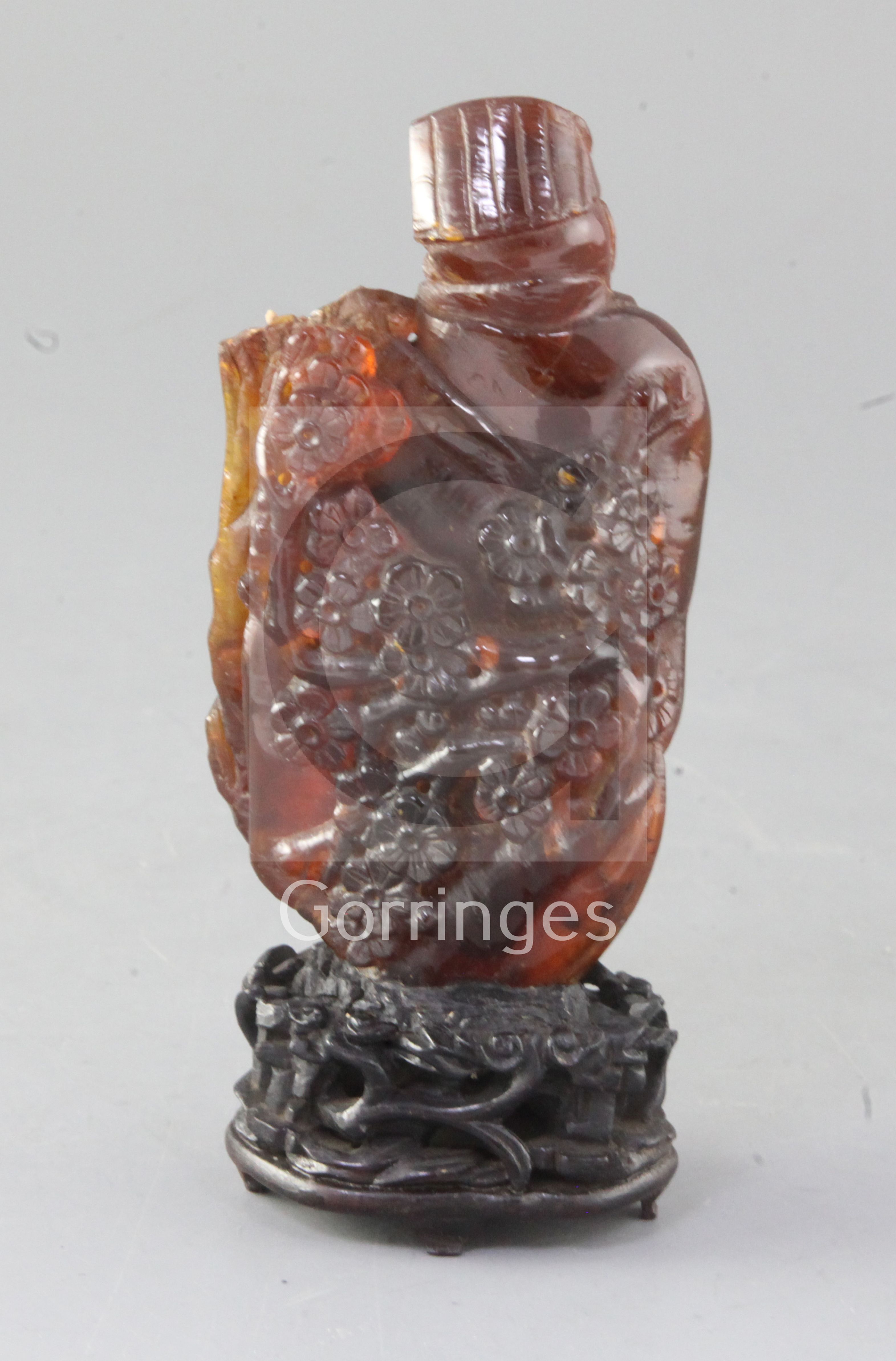 A Chinese amber group of a sage and a boy, Qing dynasty, standing before a prunus tree, attached - Image 2 of 2