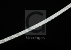 An attractive modern 18ct white gold and diamond line bracelet, set with thirty round brilliant