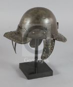 A Cromwellian helmet, hinged peak with triple bar guard, ear defences, rear peak with plume holder