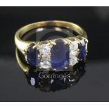 A gold, three stone sapphire and six stone diamond half hoop ring, set with oval sapphires and round