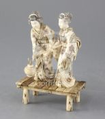 A Japanese ivory okimono of two bijin, first half 20th century, both standing on a platform, one