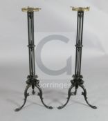 A pair of Regency cast iron candlesticks, each with tripod base cast as monopodia winged figures