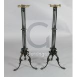 A pair of Regency cast iron candlesticks, each with tripod base cast as monopodia winged figures