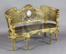An early 20th century carved giltwood canapé, with foliate carved frame, lilac jasper inset plaque