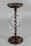 A 17th century fruitwood candle stand on spiral-turned column, H.2ft 3in. Diam. 11in. (some