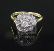 An 18ct gold, platinum and illusion set diamond nine-stone cluster ring, size O.