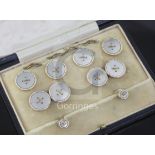A cased early/mid 20th century 9ct gold and mother of pearl eight piece dress stud set.