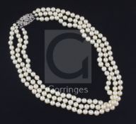 A triple strand cultured pearl choker necklace with 9ct white gold and diamond cluster clasp, in