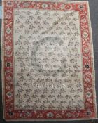 A Zeigler carpet, the ivory field with an all-over design of single floral sprigs, the madder border
