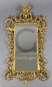A late 19th century Chippendale style giltwood and gesso rococo carved wood wall mirror, the