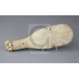 A 19th century whalebone Maori club or patu paraoa, the handle terminating in a finely carved tiki