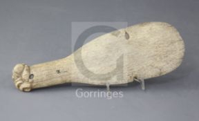 A 19th century whalebone Maori club or patu paraoa, the handle terminating in a finely carved tiki