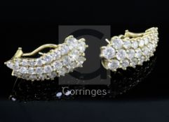 A pair of 14ct gold and diamond encrusted earrings, of tapering curved designed, each set with