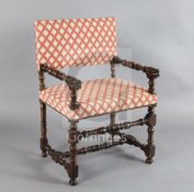 A mid 17th century French or Italian walnut armchair, with stuffed back and seat, turned arms with