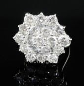 An 18ct white gold and diamond hexagonal cluster ring, size K.