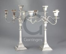 A pair of 1950's silver four branch, five light candelabra, by Alexander Smith, the detachable