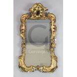 A George II carved and gilt frame looking glass, with rectangular shaped plate in a pierced scroll