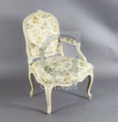 A set of four mid 18th century Louis XV painted fauteuils, with flower carved moulded frames,