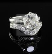 A modern platinum and diamond wedding set comprising a single stone diamond ring and eleven stone