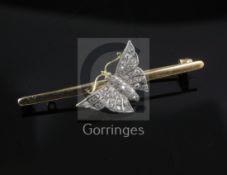 An Edwardian 15ct gold and diamond set butterfly bar brooch, 50mm.