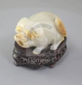 An unusual Chinese pale celadon and russet skin jade 'lion-dog' snuff bottle, 19th century, the