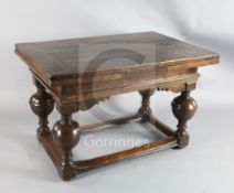 A mid 17th century Dutch oak draw leaf table with rectangular top raised on four baluster legs