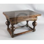 A mid 17th century Dutch oak draw leaf table with rectangular top raised on four baluster legs