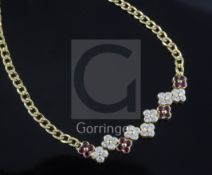 A Garrard & Co 18ct yellow gold curb-link necklace with seven diamond and four ruby conjoined four-