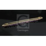 A French Cartier amethyst and 18ct gold bar brooch, channel-set with 29 square-cut amethysts, signed