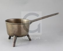 An 18th century bronze skillet, of characteristic form, the vessel raised on three feet, the