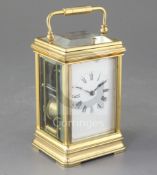 A late 19th century French brass carriage clock, with canalee case, the Roman enamelled dial with