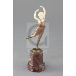 An Art Deco ivory and cold patinated bronze figure of a dancing girl, raised on hardstone plinth