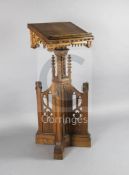 A mid 20th century Gothic revival oak lectern, the central stem carved with lancet shaped blind