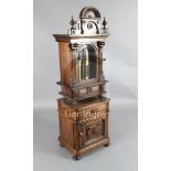 A late 19th century German upright symphonium, the walnut case of architectural form with drawer